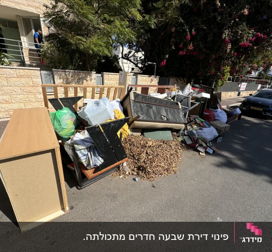ערימת רהיטים ופסולת ברחוב ליד בניין מגורים